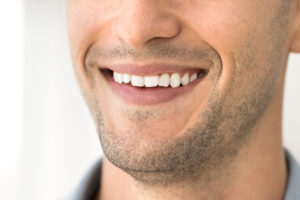 man smiling i n white room