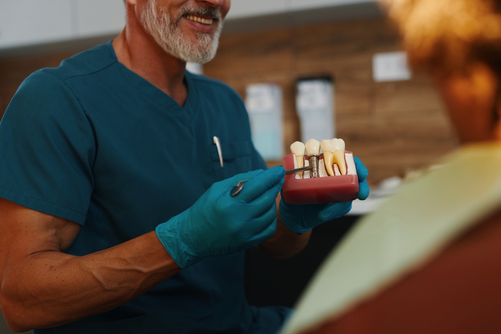 Dentist consulting with patient about front tooth treatment options in a modern office