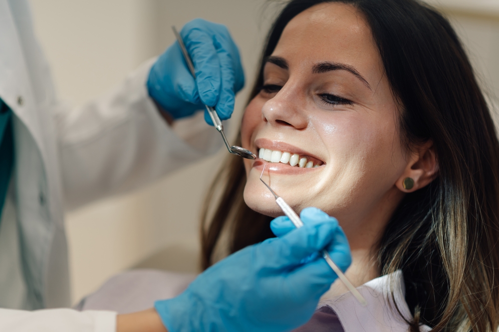 Dr. Noah Orenstein consulting with a patient in a modern dental office.